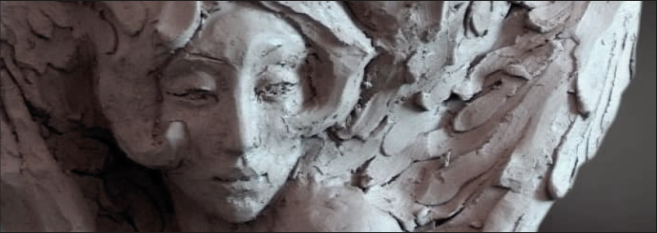 Close-up of a sculpted face with organic handmade surface